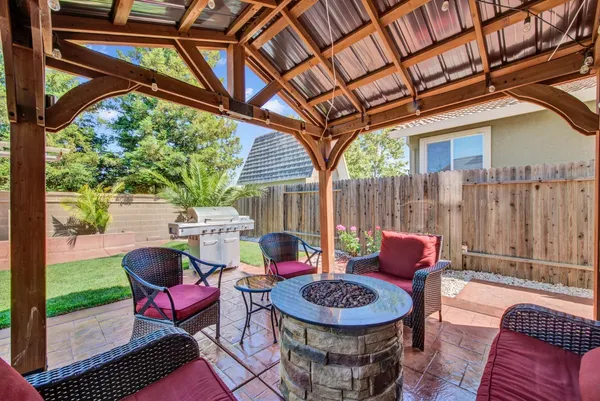 a view of a house with backyard porch and sitting area