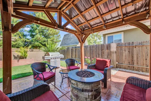 a view of a house with backyard porch and sitting area
