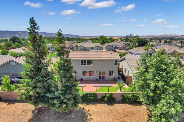 a view of a house with backyard and patio