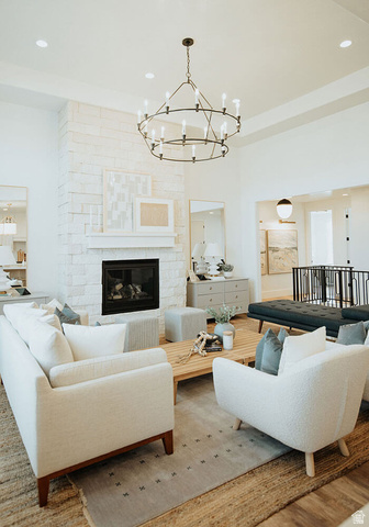 1378 North 1500 West, Unit 8 Mapleton, UT 84664 - Photo 6 of 20 Spacious living area featuring a stone-clad fireplace with a classic mantel, a two-tiered chandelier, recessed lighting, and wood-finish flooring