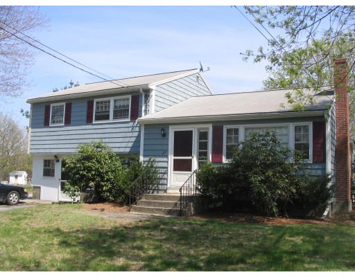 27 Chamberlain Road Chelmsford, MA 01824 - Photo 2 of 11 a front view of a house with a yard and garage