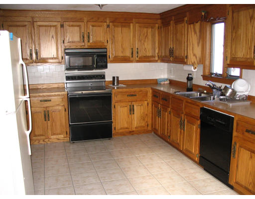27 Chamberlain Road Chelmsford, MA 01824 - Photo 9 of 11 a kitchen with a stove a sink and a microwave