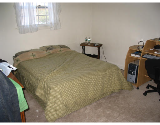 27 Chamberlain Road Chelmsford, MA 01824 - Photo 10 of 11 a bedroom with a bed and a chair
