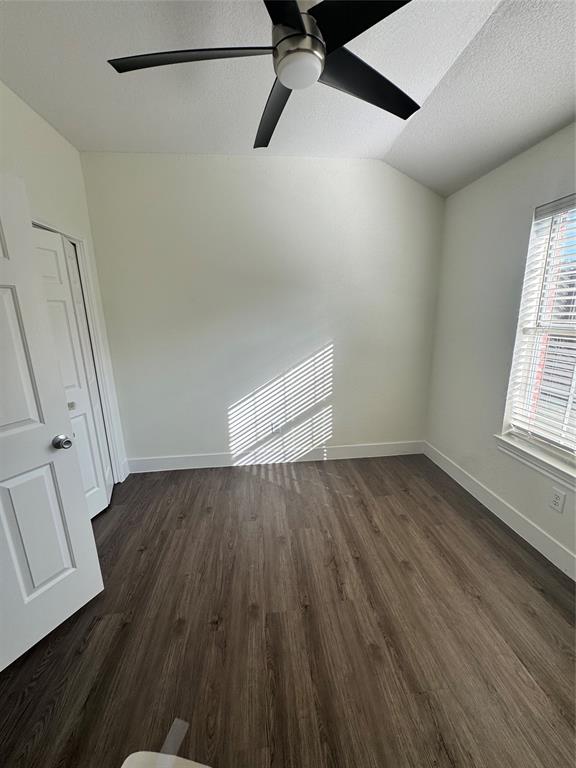 8104 Sebastian Frisco, TX 75035 - Photo 12 of 16 Spare room featuring a textured ceiling, dark wood finished floors, vaulted ceiling, and ceiling fan