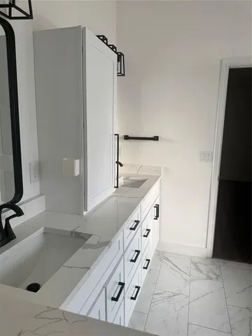 a bathroom with a tub sink and mirror