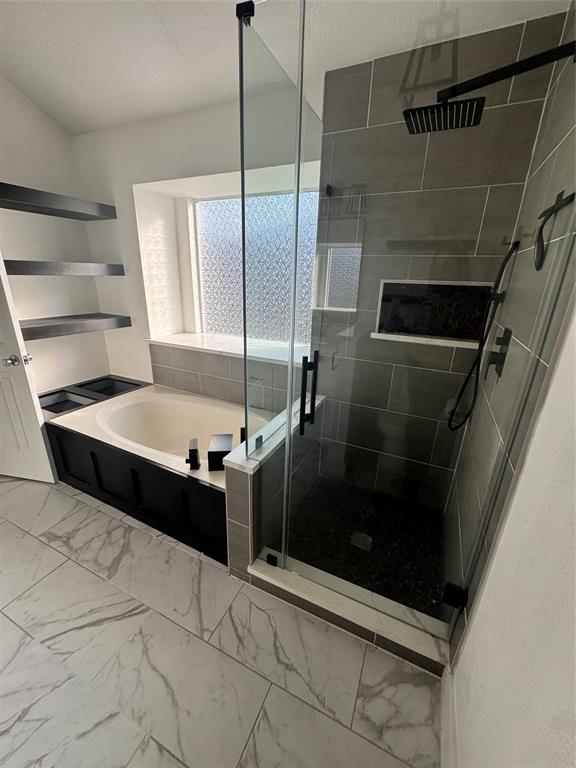 8104 Sebastian Frisco, TX 75035 - Photo 16 of 16 Bathroom with light marble finish flooring, a shower stall, and a garden tub