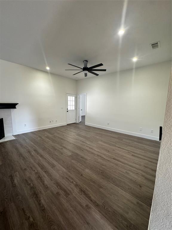 8104 Sebastian Frisco, TX 75035 - Photo 5 of 16 Unfurnished living room with dark wood finished floors, a fireplace with flush hearth, recessed lighting, and ceiling fan