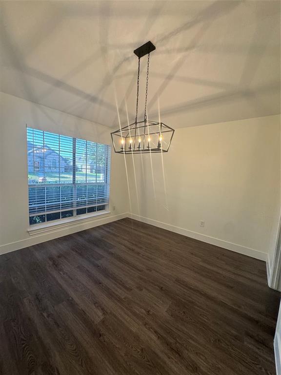 8104 Sebastian Frisco, TX 75035 - Photo 6 of 16 Unfurnished dining area featuring dark wood finished floors and lofted ceiling