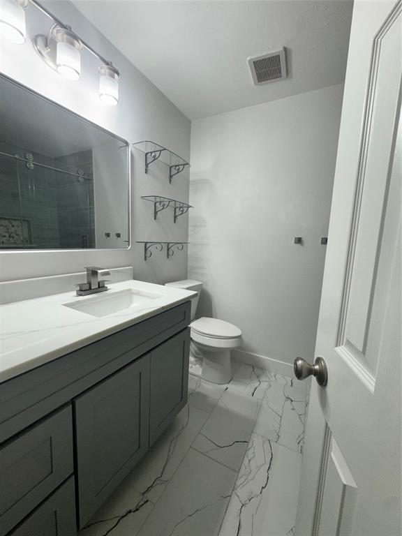 8104 Sebastian Frisco, TX 75035 - Photo 9 of 16 Full bathroom featuring vanity, tiled shower, and light marble finish floors