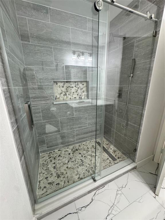8104 Sebastian Frisco, TX 75035 - Photo 10 of 16 Bathroom with a stall shower and marble finish flooring