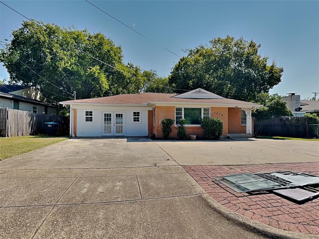 a front view of a house with a yard and a garage