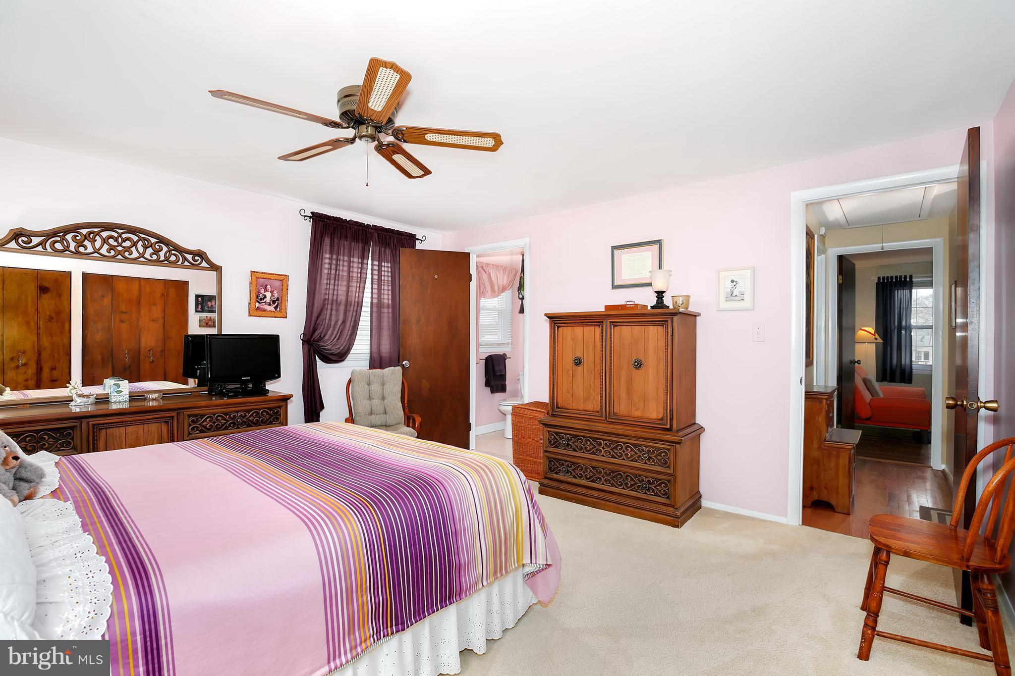 9007 Kilbride Road Baltimore, MD 21236 - Photo 16 of 30 a bedroom with a bed and a chandelier