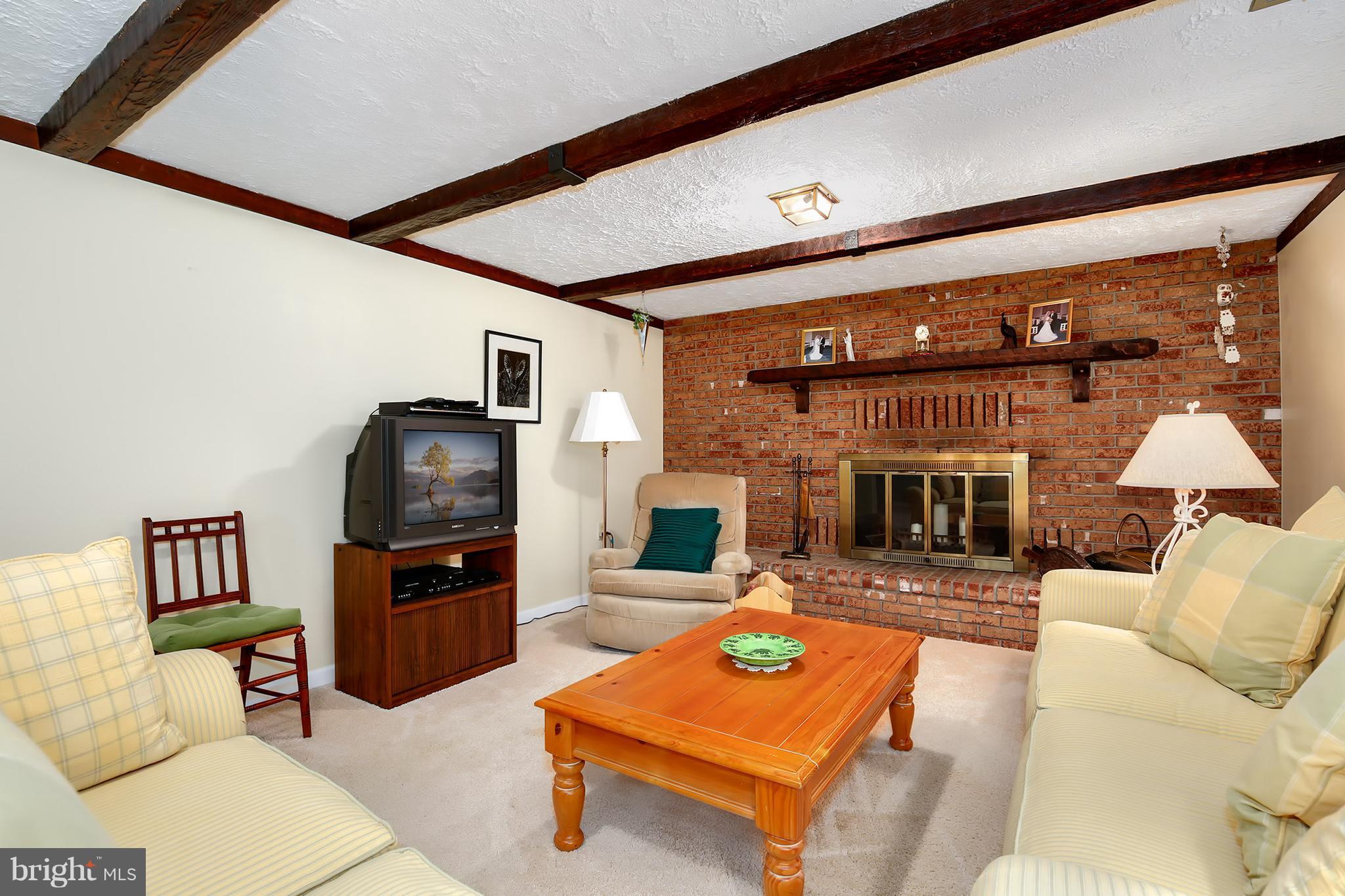9007 Kilbride Road Baltimore, MD 21236 - Photo 20 of 30 a living room with furniture and a fireplace