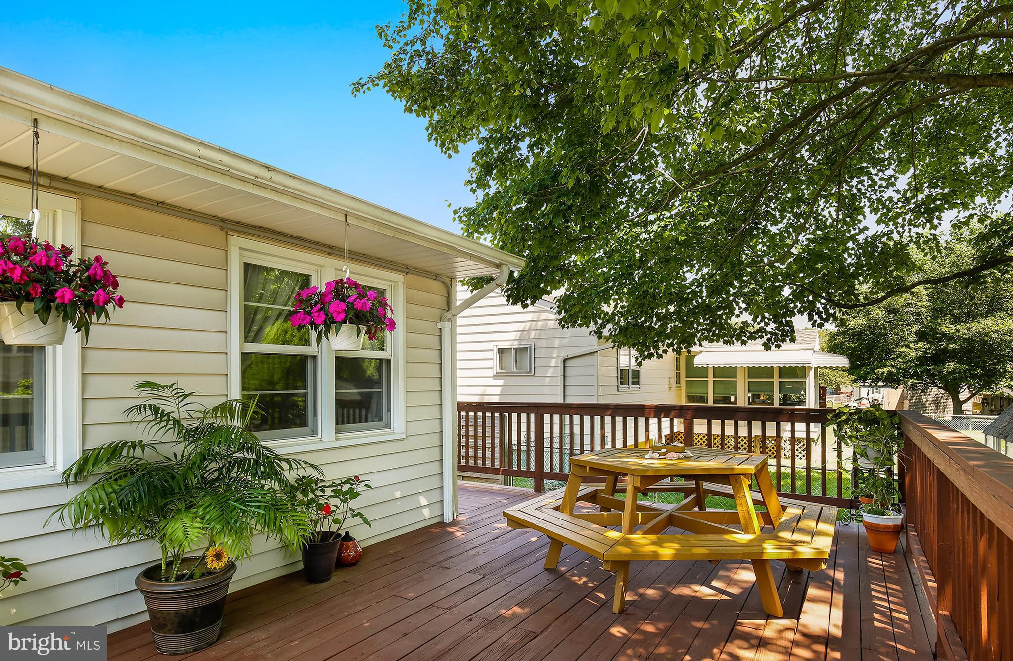 9007 Kilbride Road Baltimore, MD 21236 - Photo 25 of 30 a balcony with wooden floor and potted plants