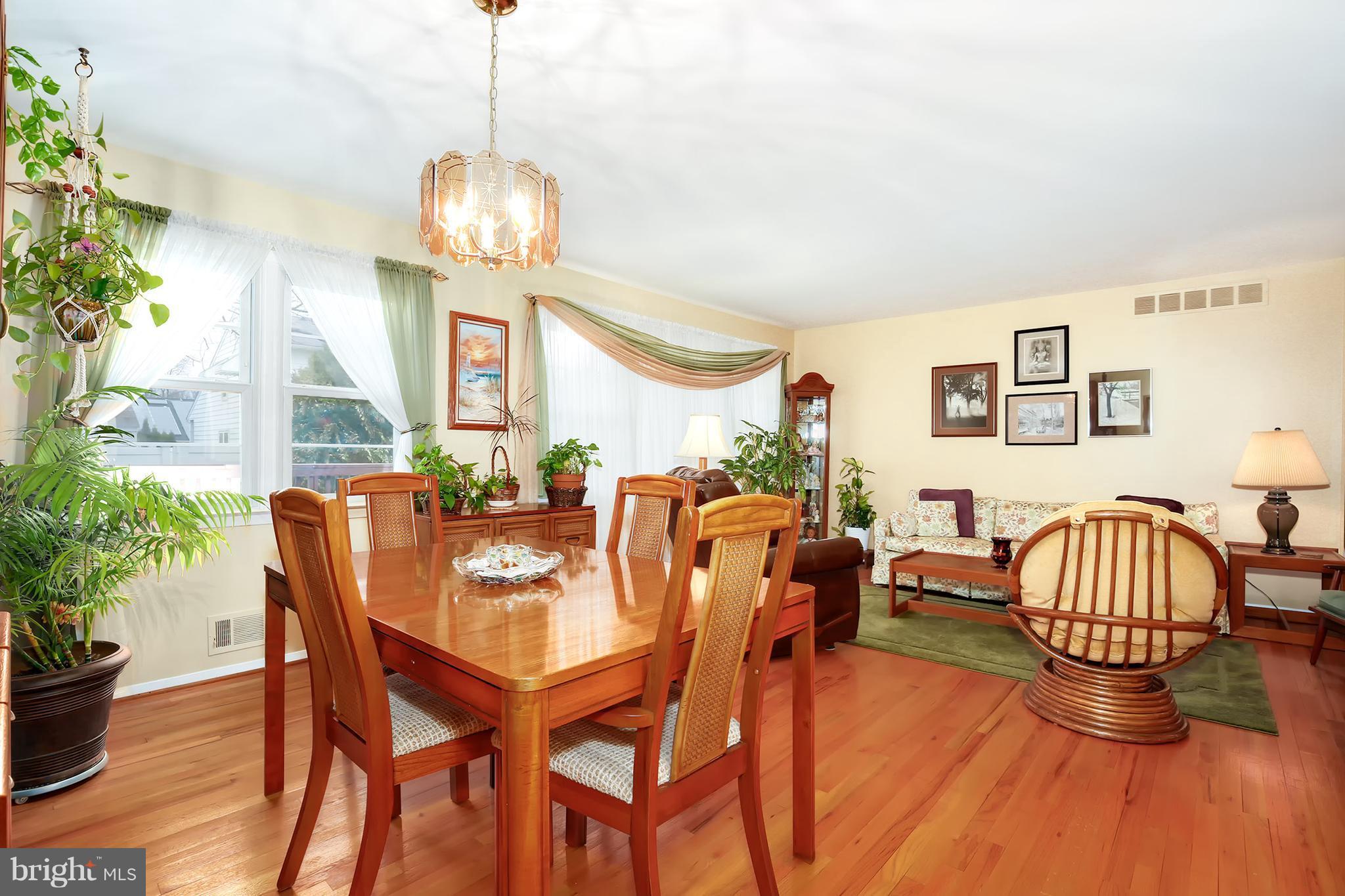 9007 Kilbride Road Baltimore, MD 21236 - Photo 6 of 30 a dining room with furniture a chandelier and wooden floor