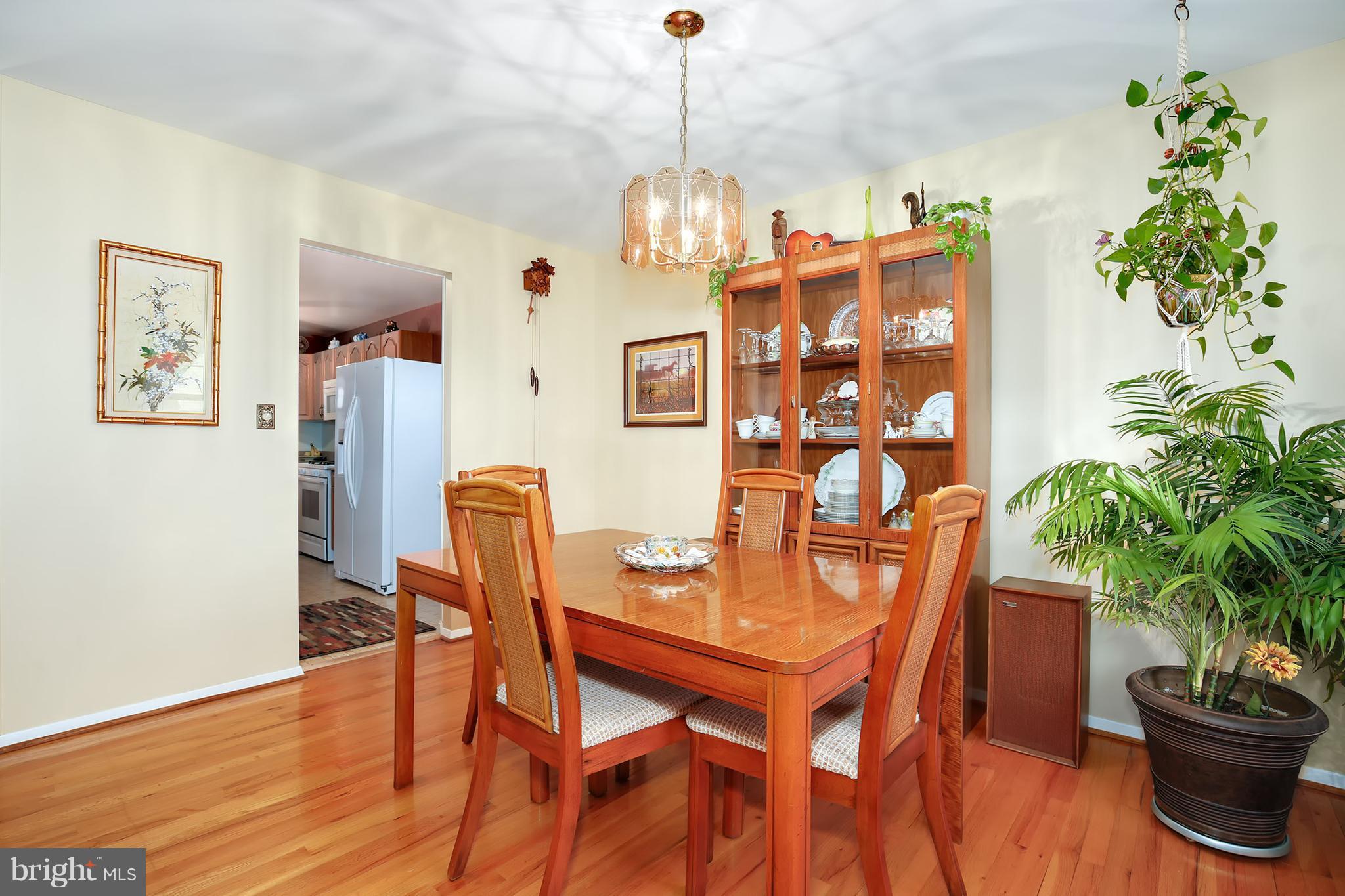 9007 Kilbride Road Baltimore, MD 21236 - Photo 7 of 30 a dining room with furniture potted plants and wooden floor