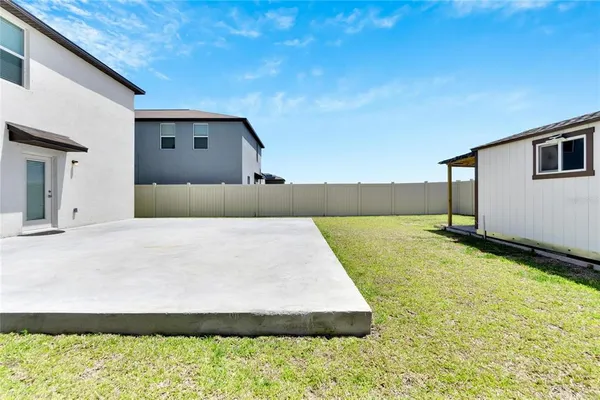 a backyard of a house with a yard and seating space