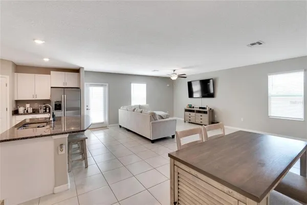 a living room with furniture and a ceiling fan