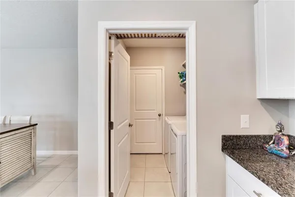 a bedroom with a bed and a chandelier fan