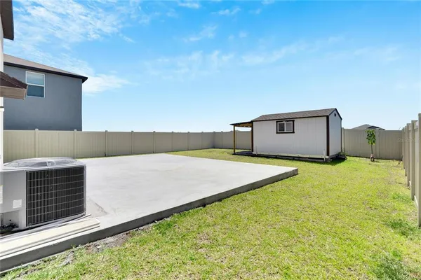 a view of backyard with trampoline