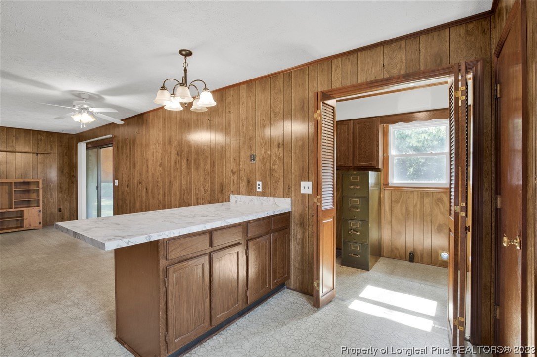 325 McIntosh Road Carthage, NC 28327 - Photo 11 of 30 a view of a hallway with wooden cabinet and chandelier