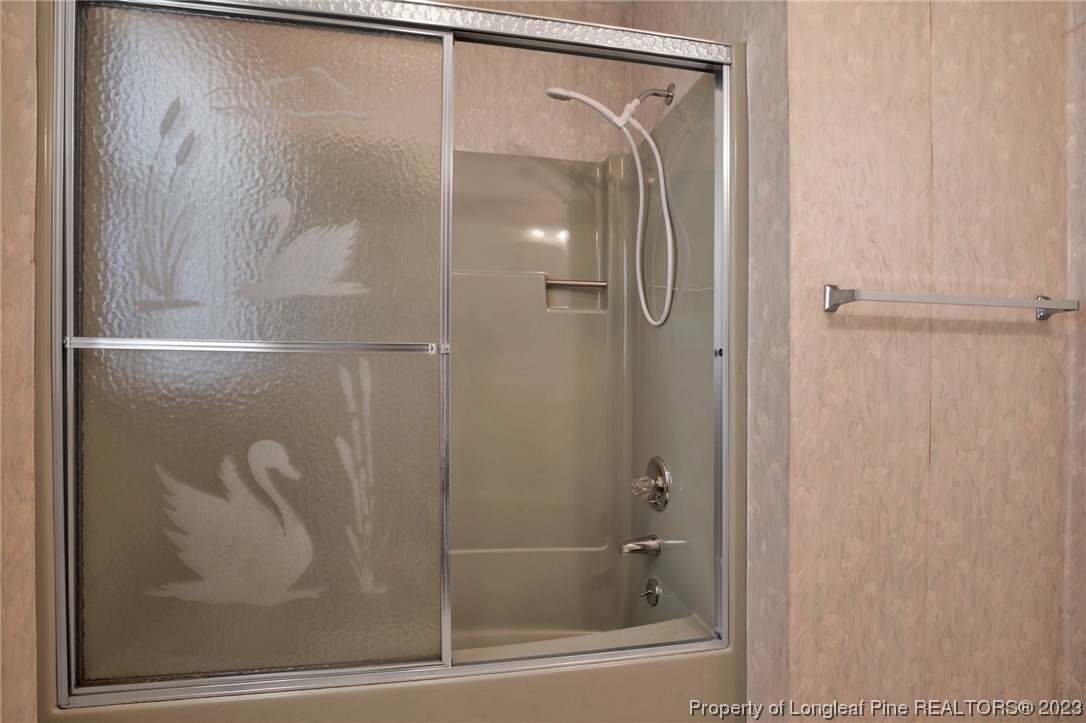 325 McIntosh Road Carthage, NC 28327 - Photo 14 of 30 a bathroom with a glass shower door