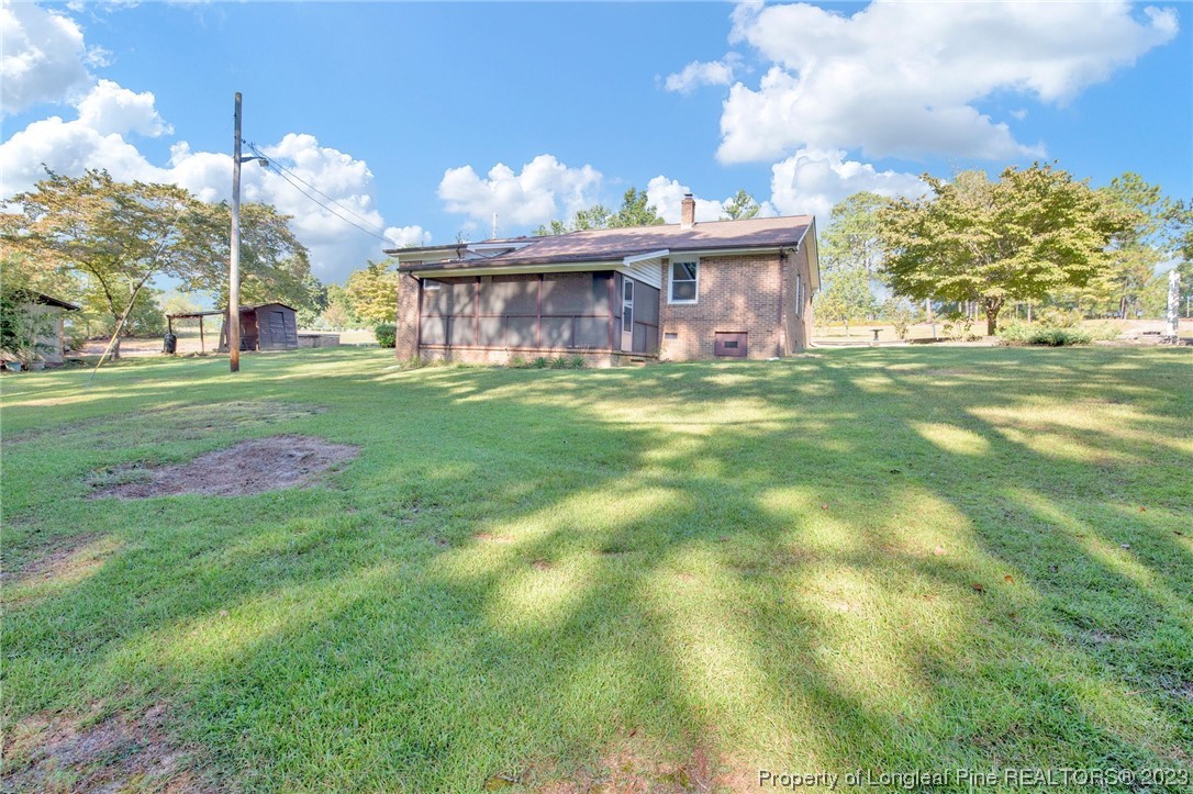 325 McIntosh Road Carthage, NC 28327 - Photo 21 of 30 a view of a brick house with a big yard