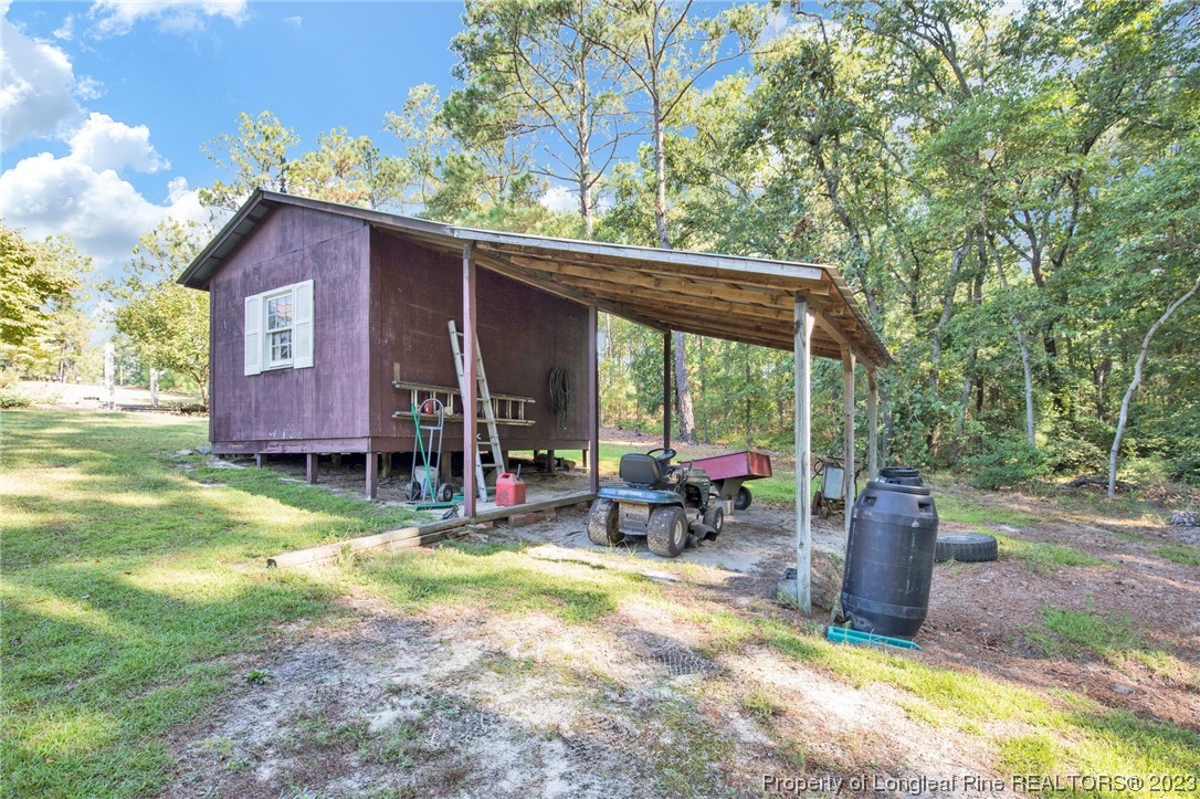 325 McIntosh Road Carthage, NC 28327 - Photo 24 of 30 a view of a patio with a table chairs and a yard