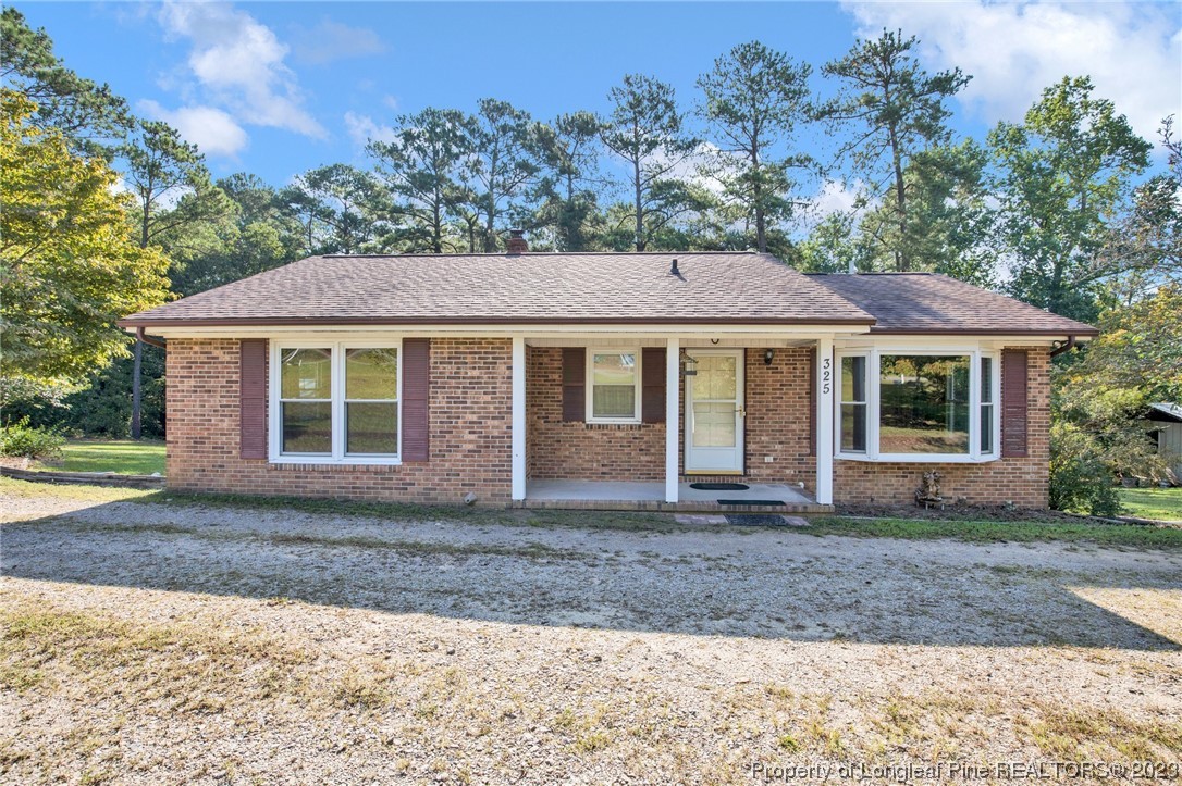 325 McIntosh Road Carthage, NC 28327 - Photo 27 of 30 a front view of a house with a garden and yard