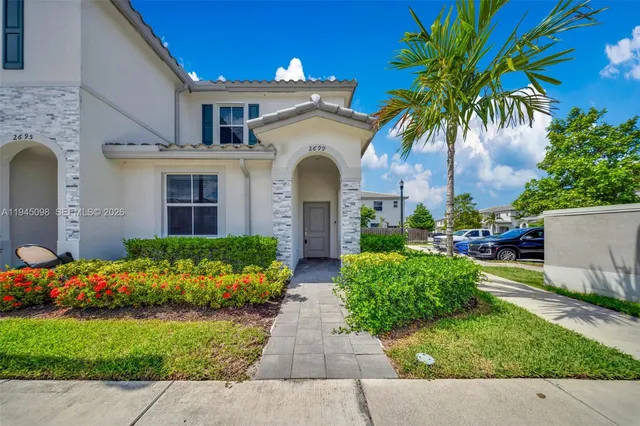 a front view of a house with a garden
