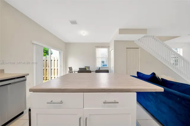 a view of kitchen and hall with wooden floor