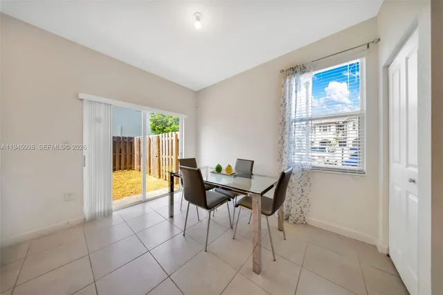 a view of a dining room with furniture and a window