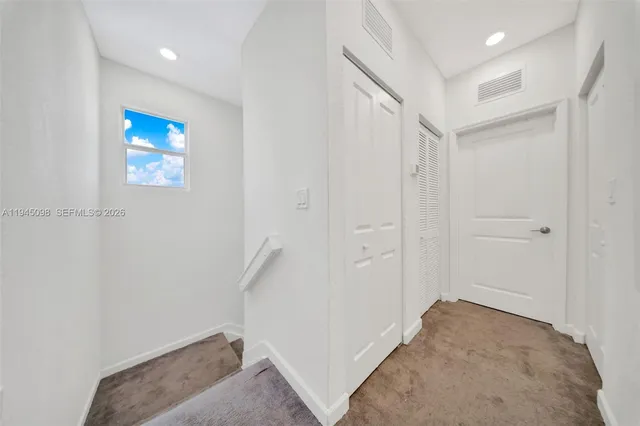 a view of hallway with a ceiling fan