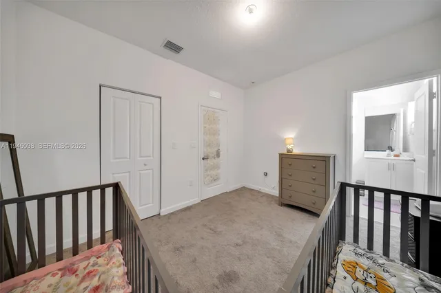 a view of a hallway to a livingroom with furniture