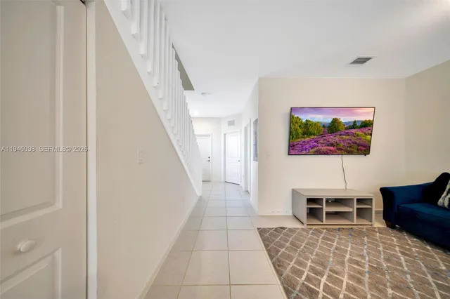 a living room with furniture a rug and a wall painting