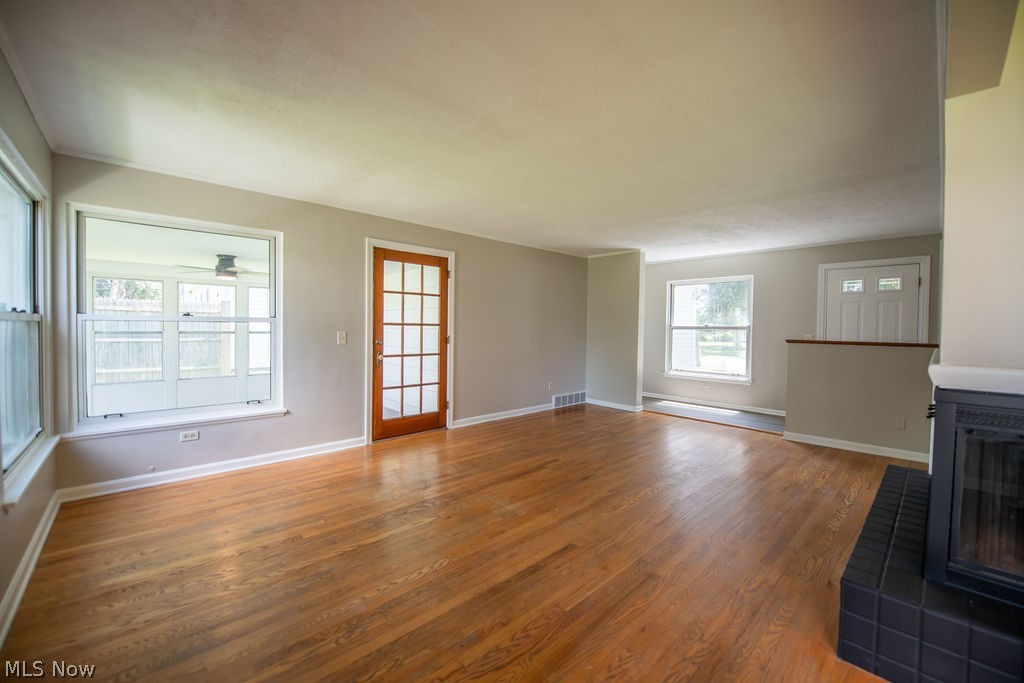 4221 2nd Street Northwest Canton, OH 44708 - Photo 6 of 35 Living room view featuring a fireplace and an abundance of natural light.