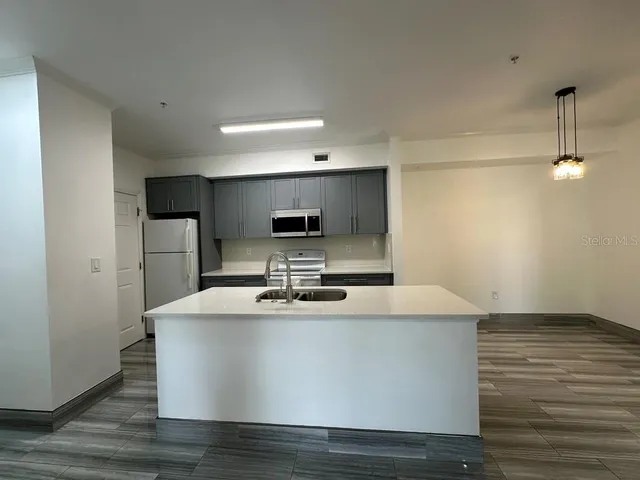 a large white kitchen with a sink