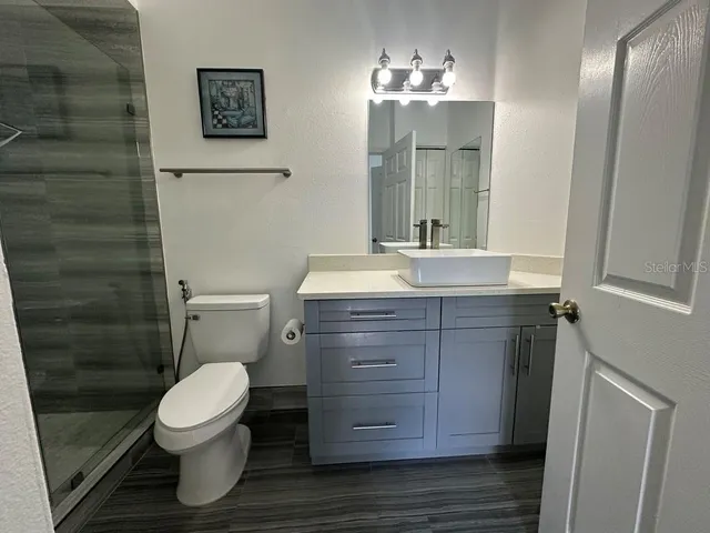 a bathroom with a sink toilet and shower