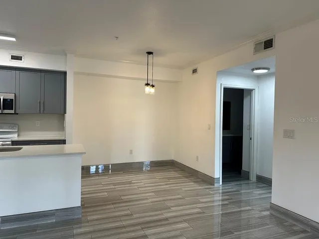 a view of a kitchen with wooden floor and a sink