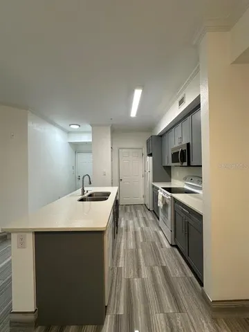 a kitchen with a sink stove and refrigerator