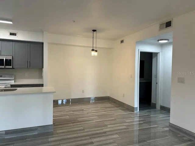 a view of a kitchen with wooden floor