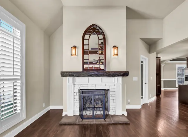 a living room with a fireplace with wooden floor