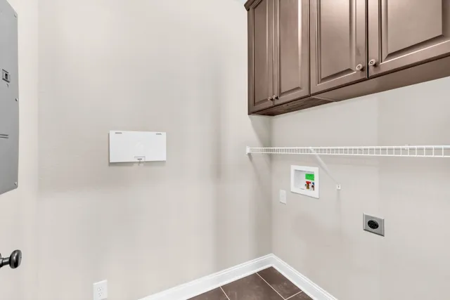 a view of wooden floor and a chandelier fan in a room