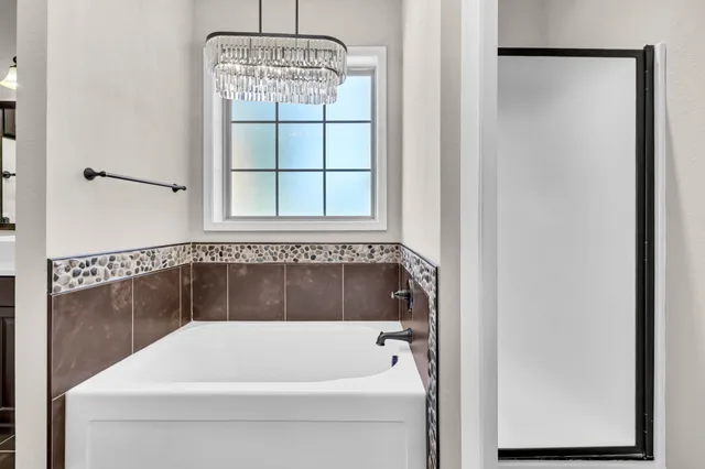 a bathroom with a sink a mirror and a shower