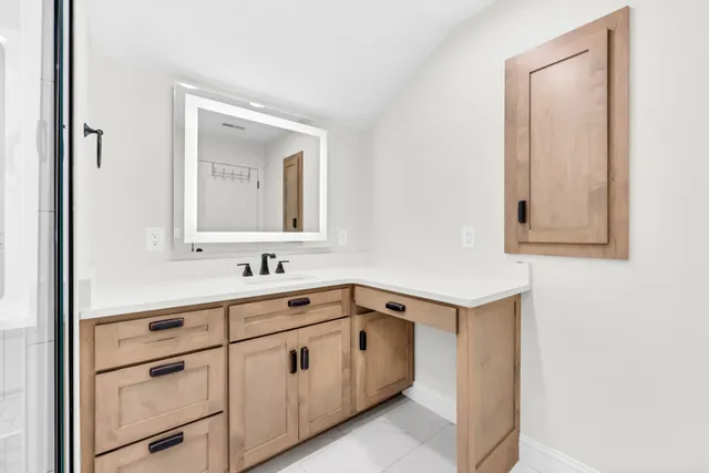 a view of a front door and porch with wooden floor