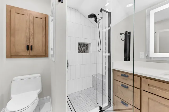 a bathroom with a toilet and a shower