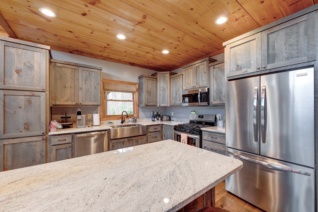 1601 Shady Falls Road Blue Ridge, GA 30513 - Photo 12 of 78 a kitchen with granite countertop a refrigerator stove top oven and sink
