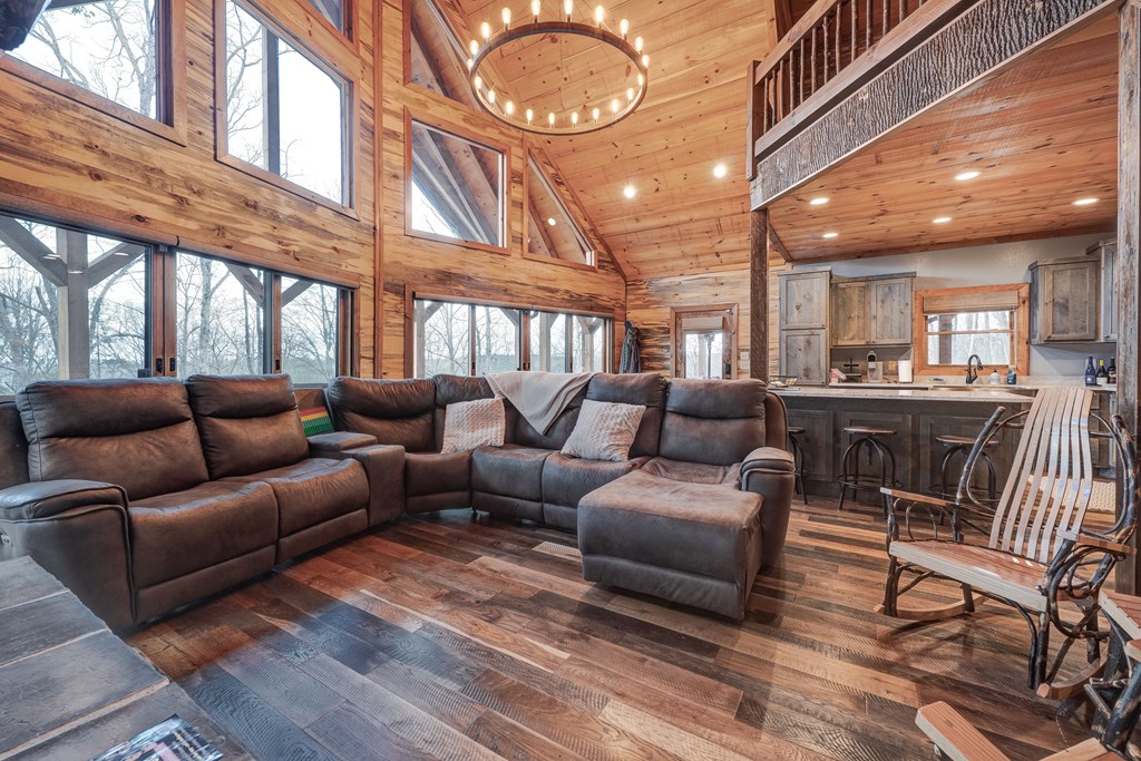 1601 Shady Falls Road Blue Ridge, GA 30513 - Photo 19 of 78 a living room with furniture a large window and wooden floor