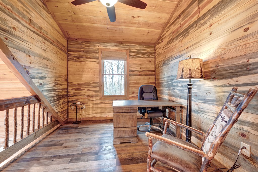 1601 Shady Falls Road Blue Ridge, GA 30513 - Photo 32 of 78 a room with lots of wooden furniture and windows