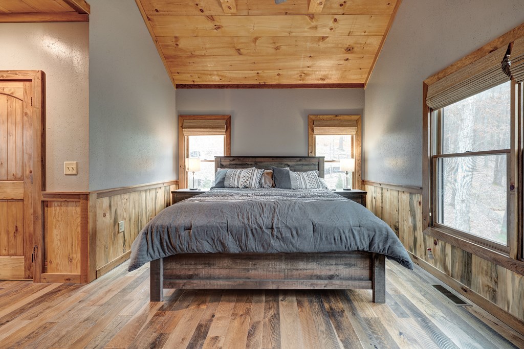 1601 Shady Falls Road Blue Ridge, GA 30513 - Photo 36 of 78 a bedroom with a bed and wooden floor